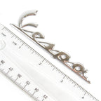 'VESPA' LEGSHIELD CHROME BADGE (EMBLEM) 4 INCHES LONG (520530 57356R 623205 656219)
