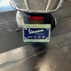 "VESPA of CALIFORNIA" CHROME & GREEN LICENSE PLATE FRAME (NEW OLD STOCK)